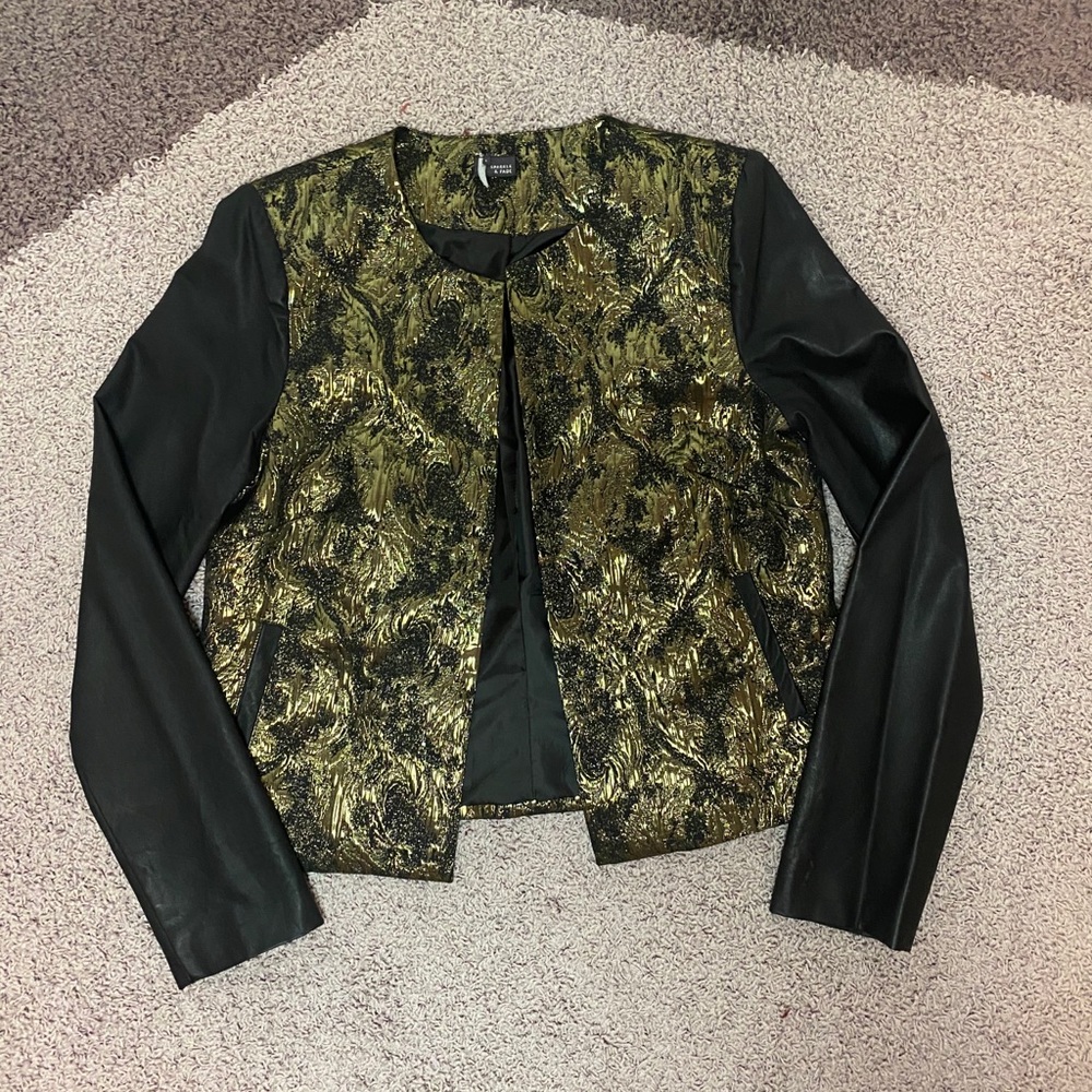 Gold embossed jacket w/ black leather sleeves